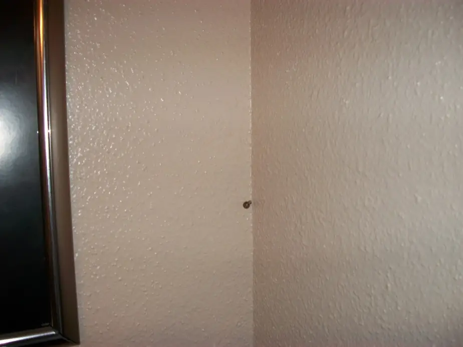 Screw protruding from wall corner
