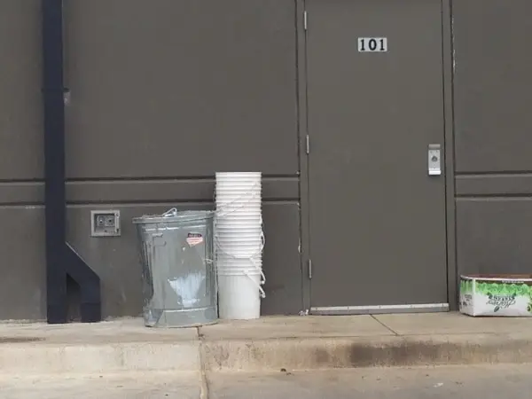 Buckets left outside behind bakeries and restaurants.